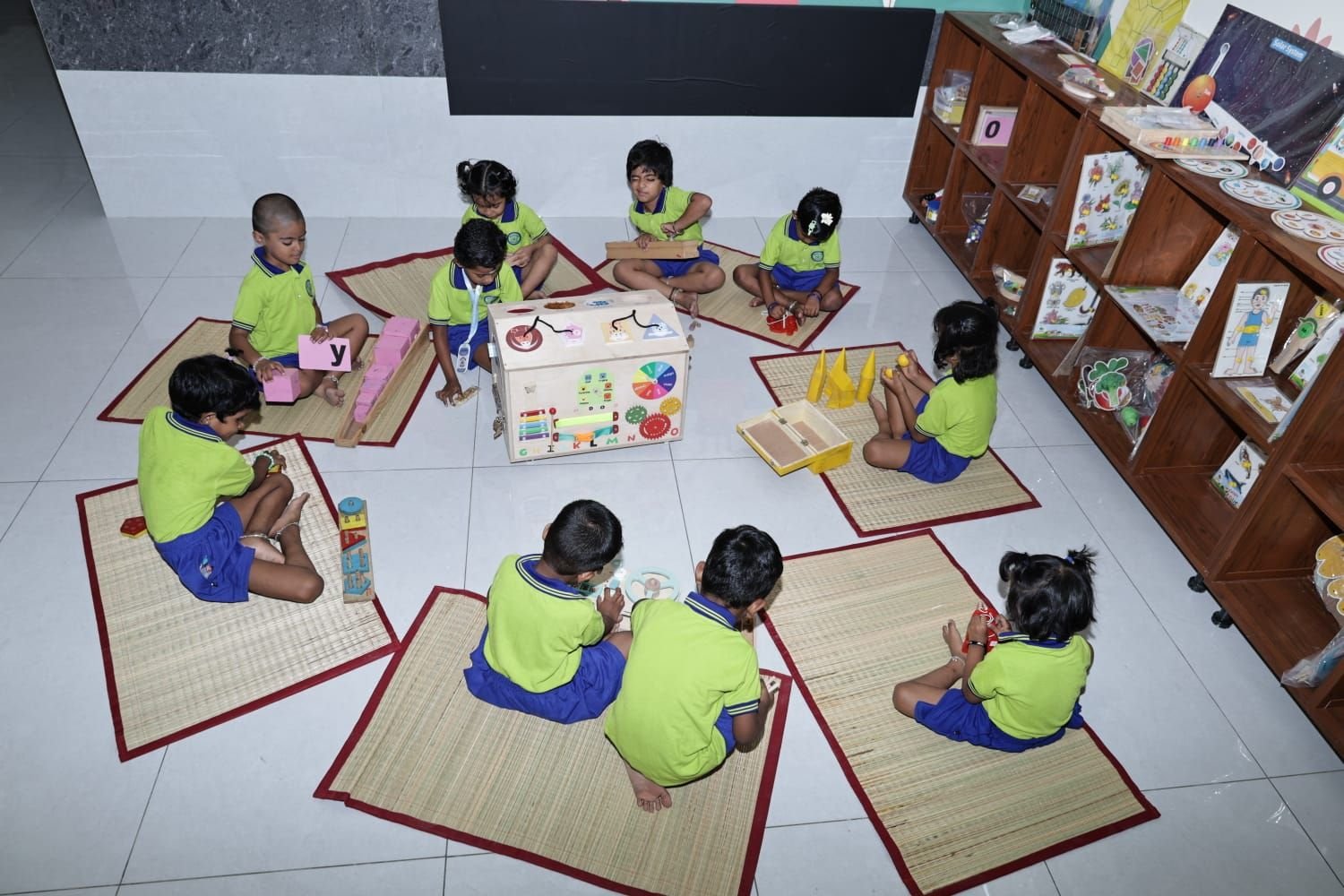 Children in a circle exploring Montessori learning materials