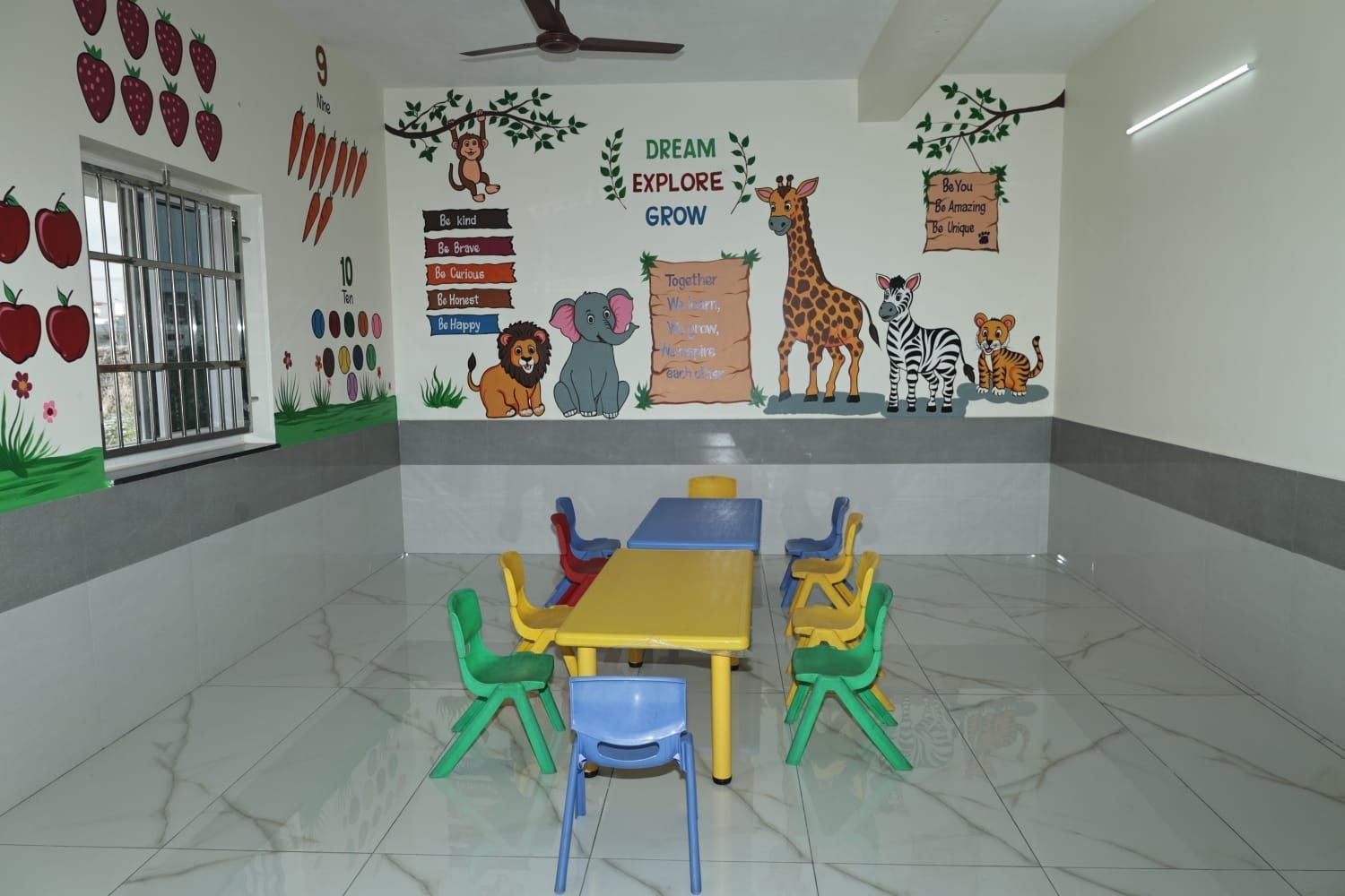 A classroom decorated with a Dream, Explore, Grow mural