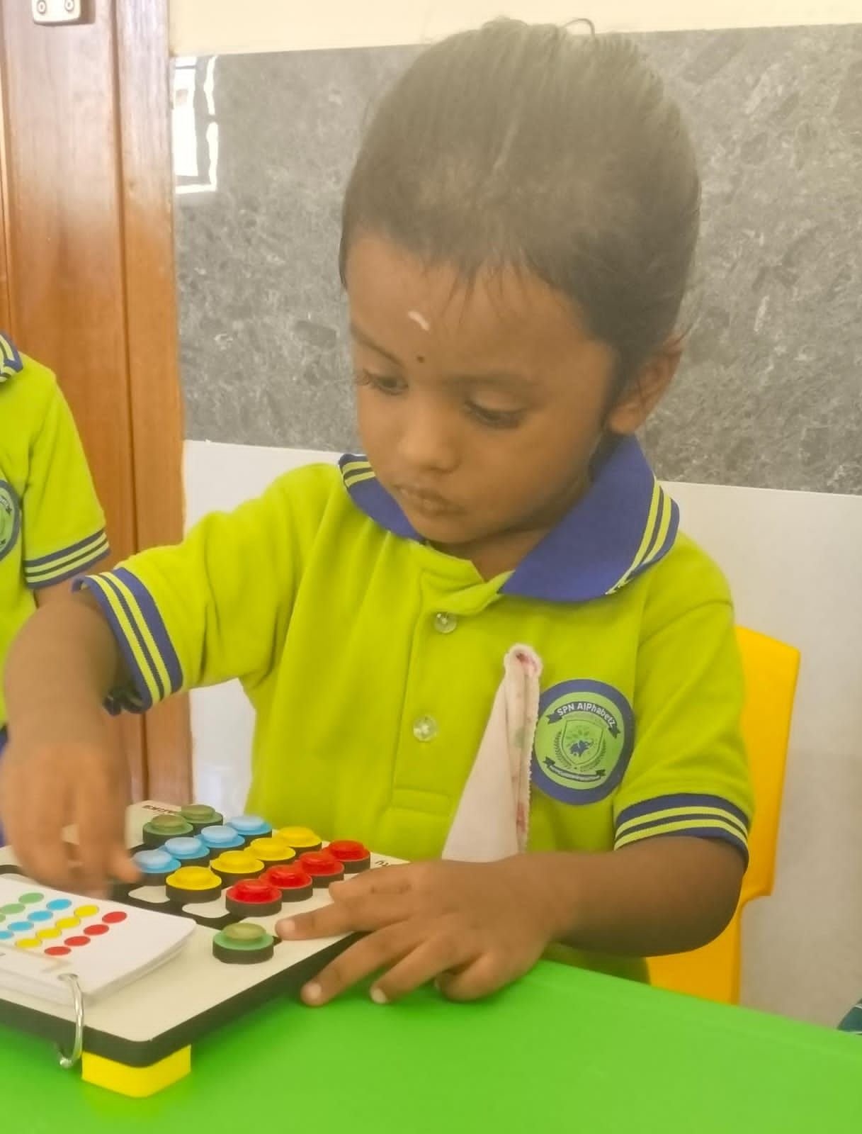 A student engrossed in a hands-on learning board