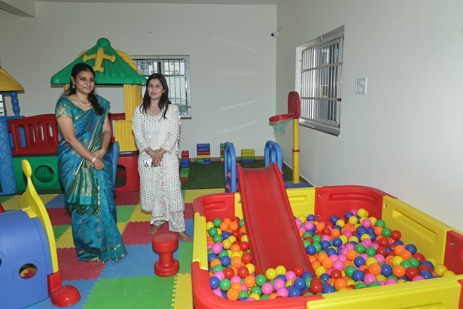 Visitors touring the indoor play area and ball pit