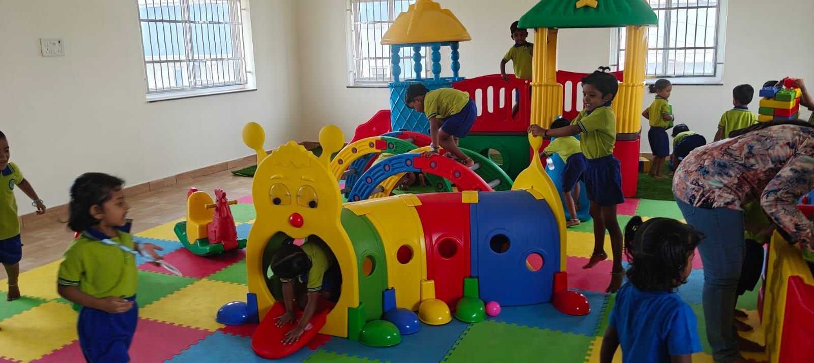 Children climbing on the indoor playground structure