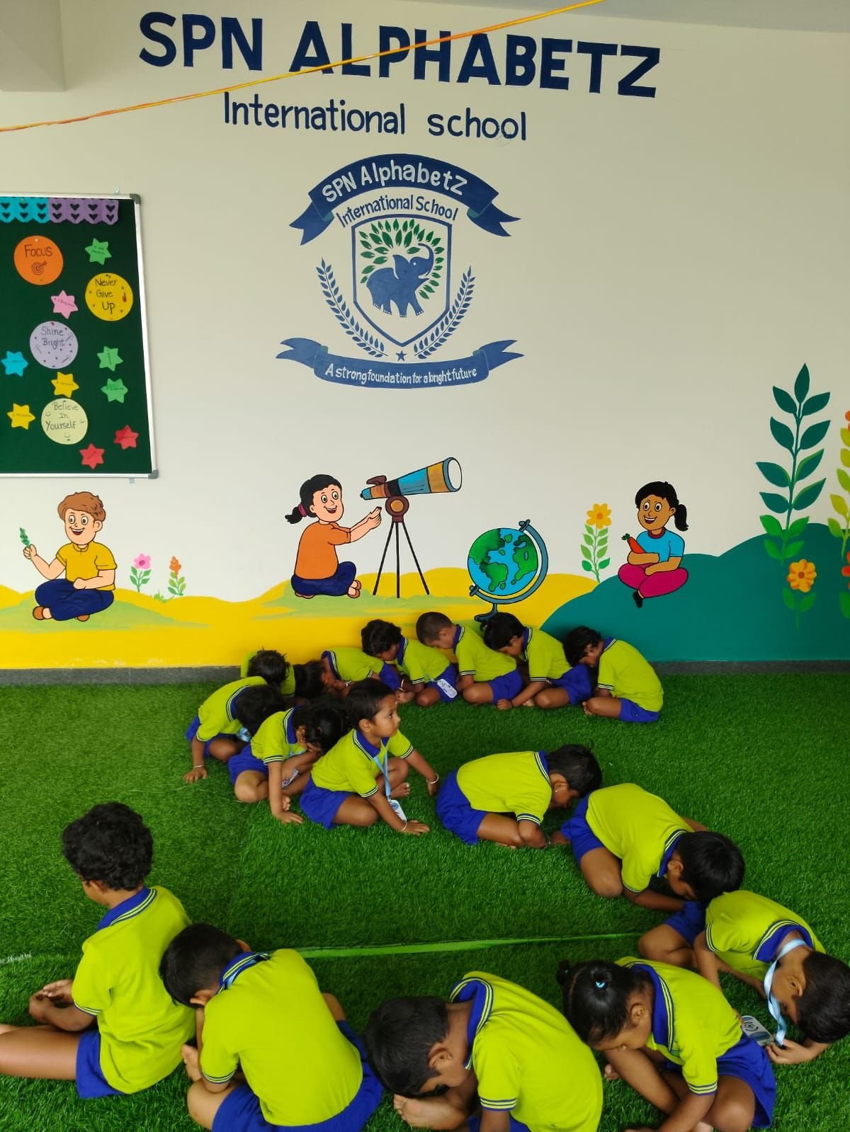 Students exploring and playing on the astro-turf activity room
