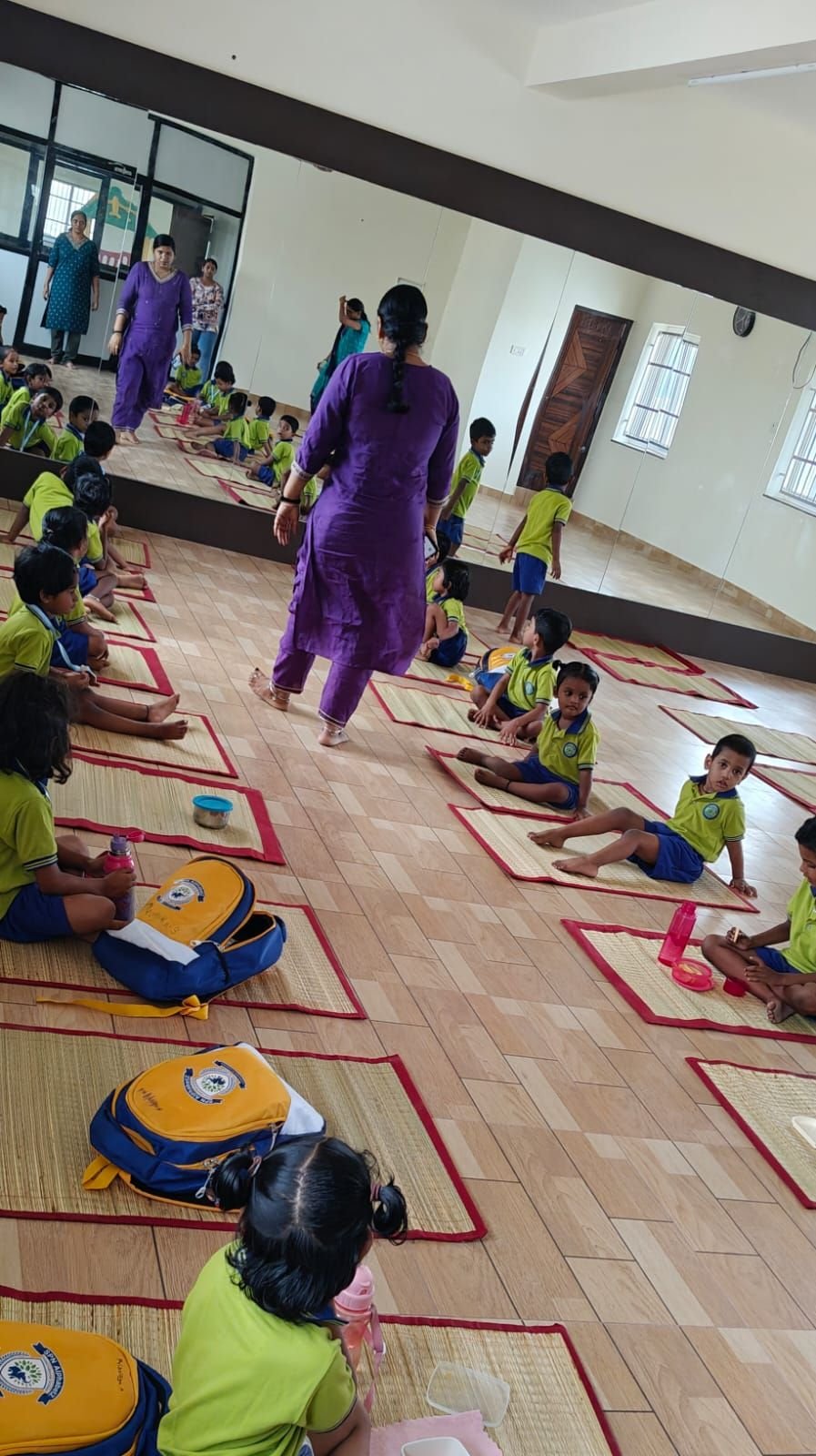Children seated on mats for a yoga and movement session